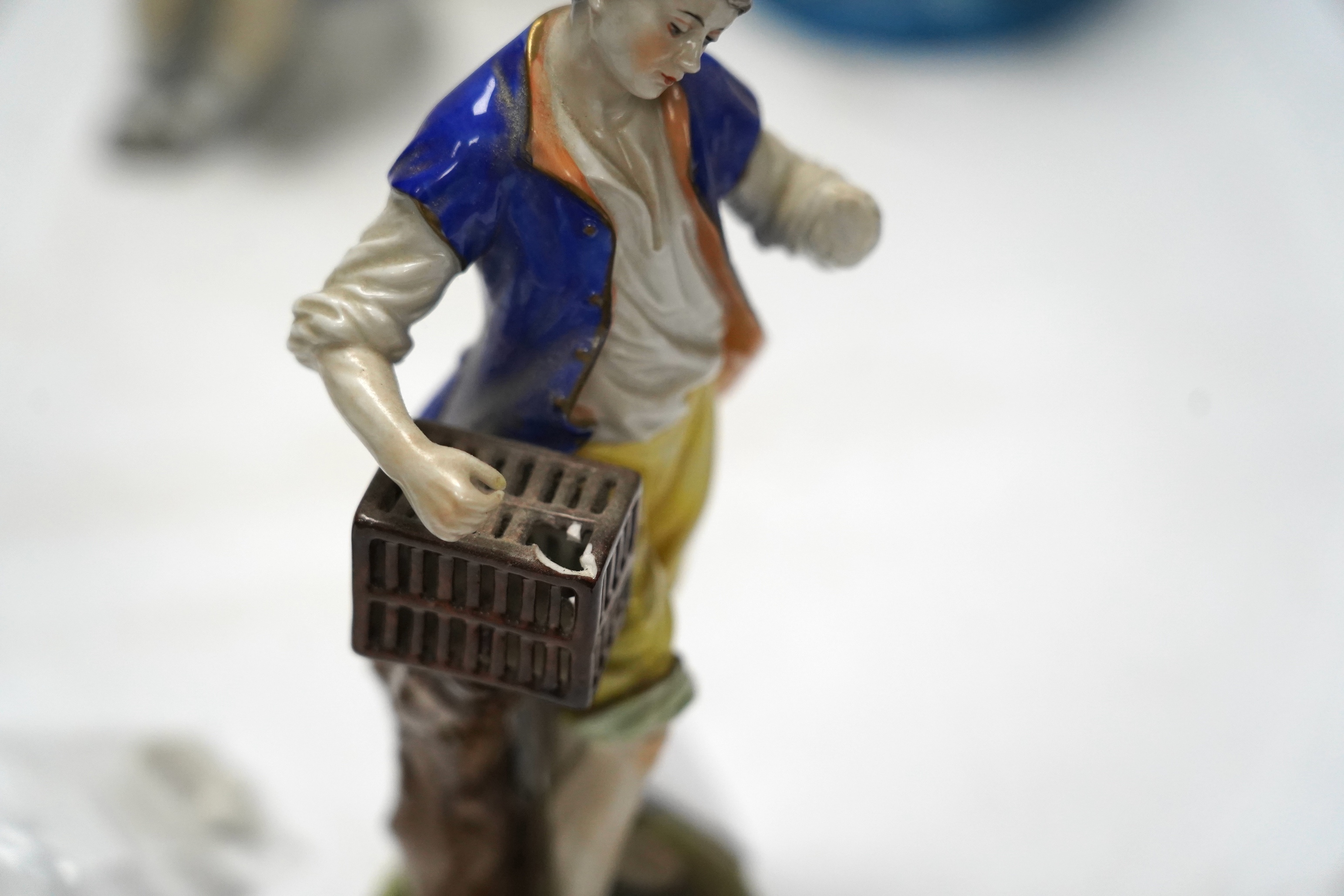Three late 19th century porcelain putti spill vases and four smaller figurines, tallest 23cm high
